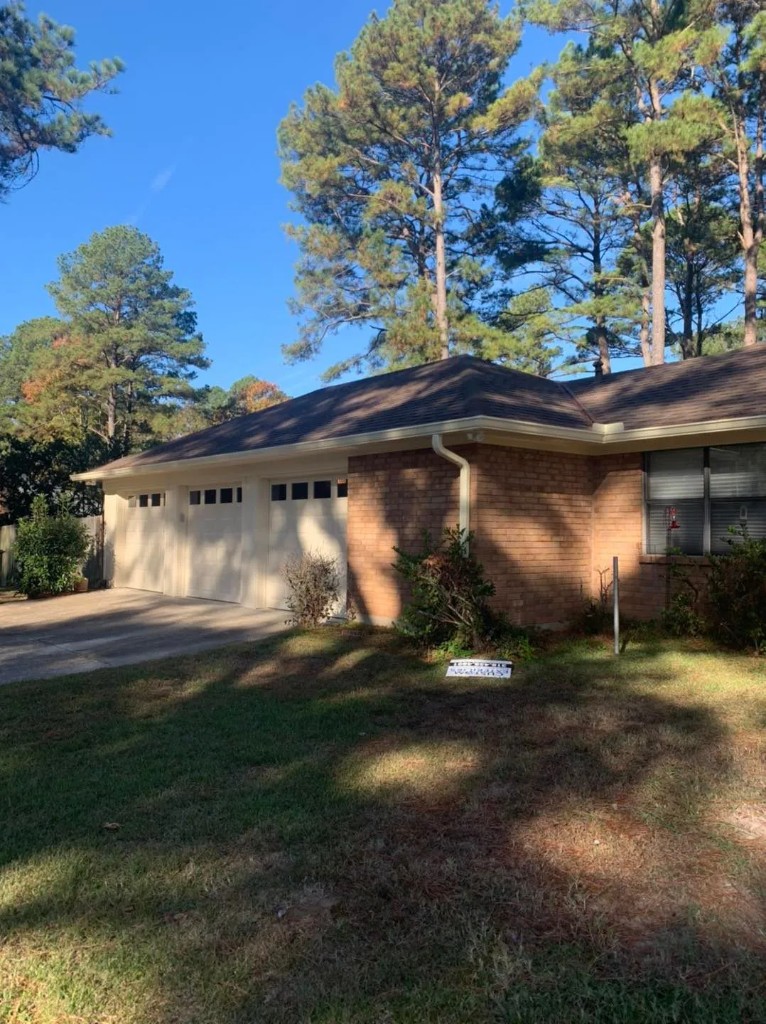 Dark ranch-style home viewed across the swimming pool