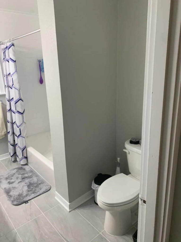 Updated bathroom with tub, shower, and gray tile flooring
