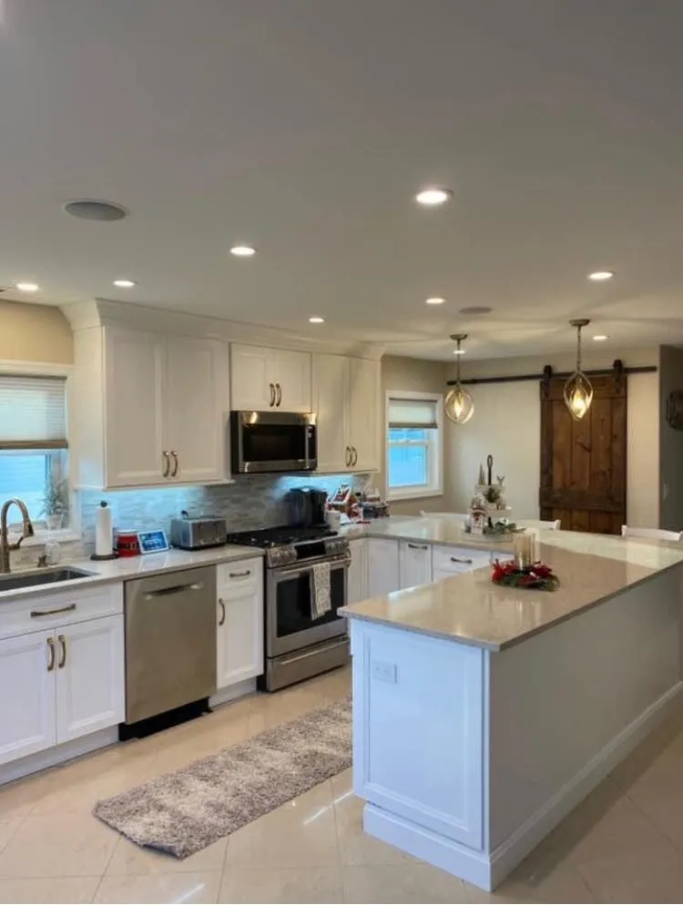 Modern white kitchen with island and stainless steel appliances