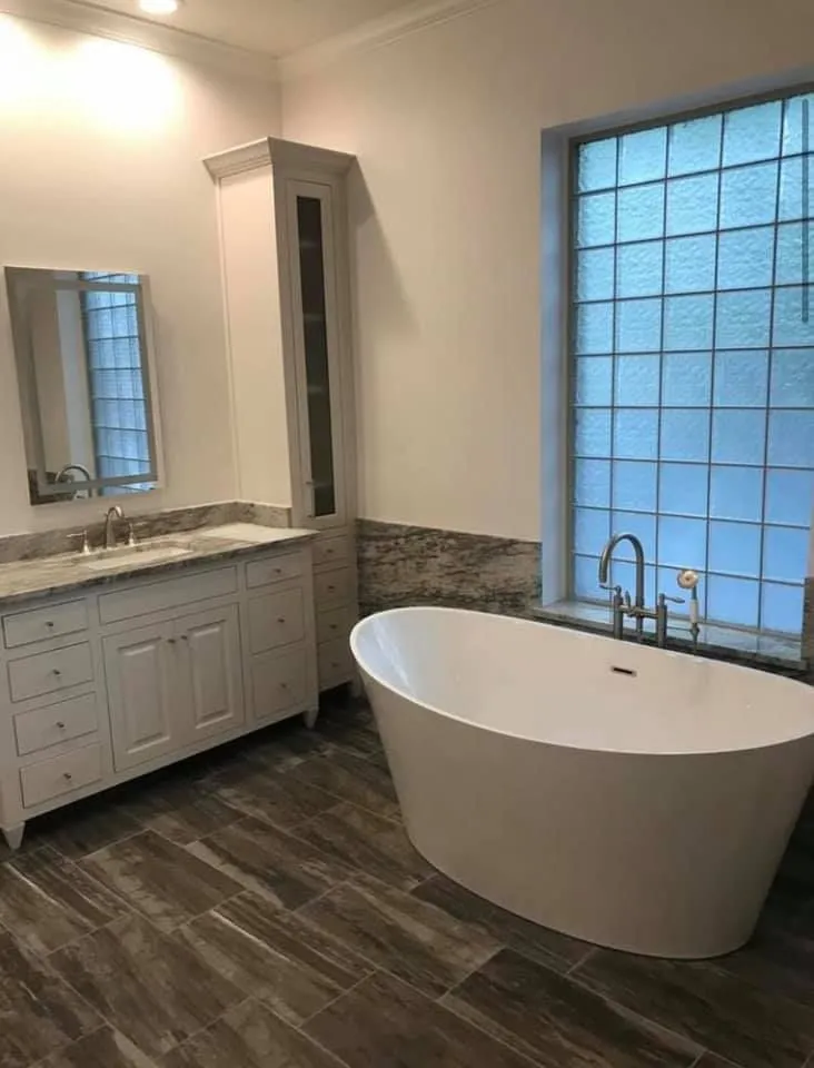 Bathroom with freestanding tub and marble vanity