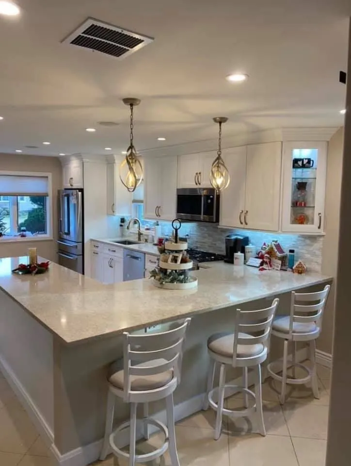 Kitchen renovation with peninsula seating and pendant lighting